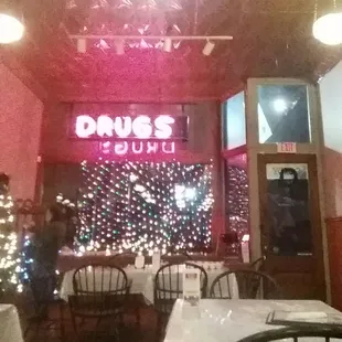 a restaurant with a christmas tree in the background