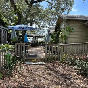 a patio with a table and umbrella
