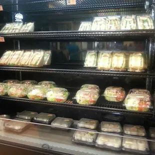 a display of sandwiches and salads
