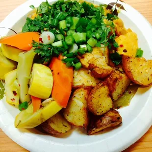 Turkey stew with steamed veggies and seasoned baked potatoes.
