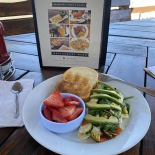 Veggie omelet , avocado , strawberries sourdough toast