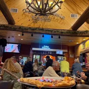 a large group of people eating pizza