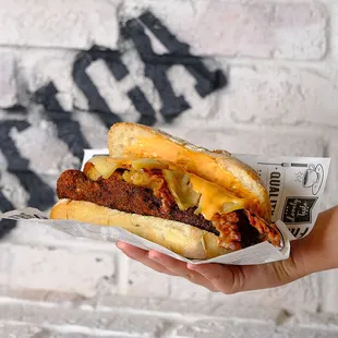 a hand holding a sandwich