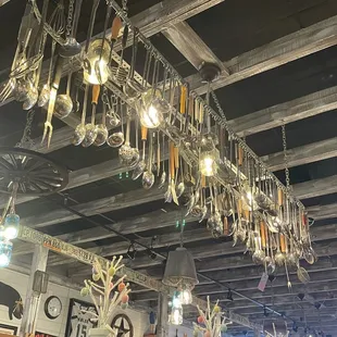 a ceiling full of hanging utensils