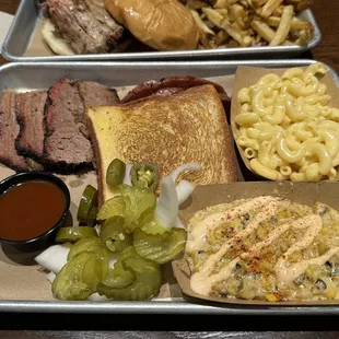 Two meat plate with brisket, German sausage, Texas street corn, and Mac &amp; cheese