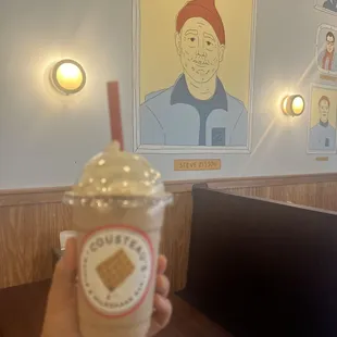  hand holding a cup of milkshake