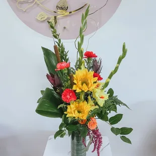Autumn arrangement of yellows, reds, oranges, purples and greens. Modern, exotic design.
