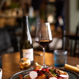 a plate of food and a glass of wine