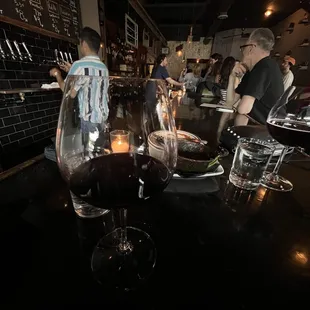 a group of people standing around a bar