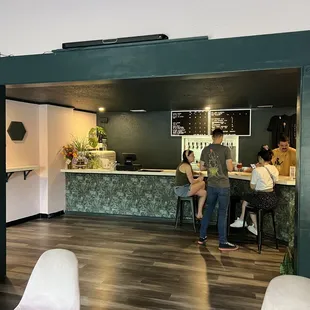 a group of people sitting at a bar