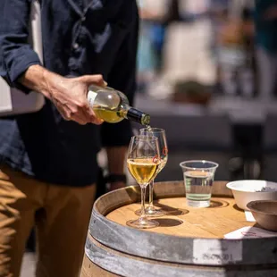 a man pouring a glass of wine