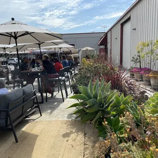 a patio area with tables and umbrellas