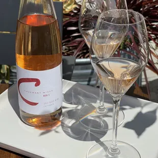 two glasses of wine and a bottle of wine
