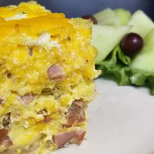 Ham and cheese quiche with a side of fruit