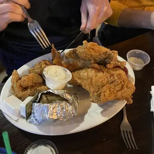 a plate of fried chicken and other food items