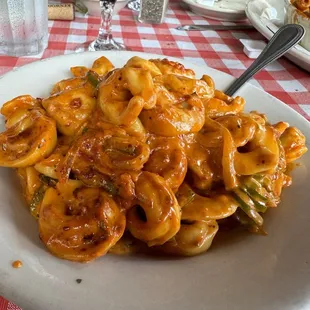 Tortolini, peppers and onions with pink sauce. The pink sauce is the best sauce! And always get the Abruzi Bread!