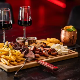 two glasses of wine and a platter of food