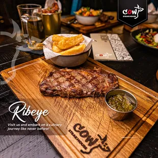 ribeye steak on a wooden cutting board