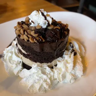 a chocolate cake with whipped cream and nuts