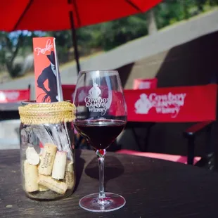 a glass of wine and corks