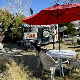 a table with chairs and an umbrella