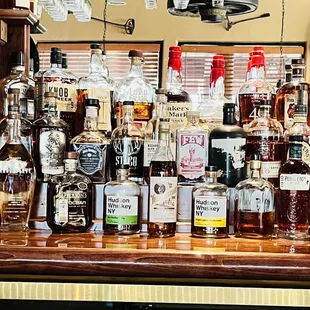  a variety of liquor bottles on a bar