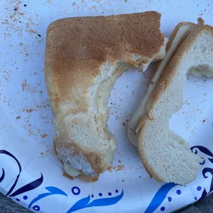 a half eaten sandwich on a plate