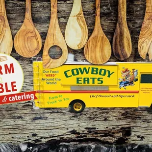 a food truck and wooden spoons