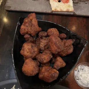 a plate of chicken nuggies and a bowl of coleslaw slaw