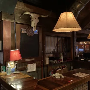 a bar with a cow skull on the wall