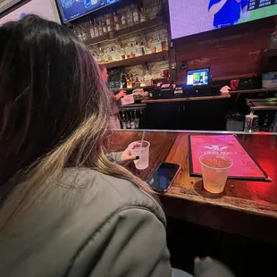 a woman sitting at a bar