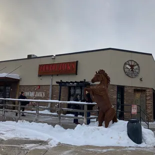 a statue of a horse in the snow