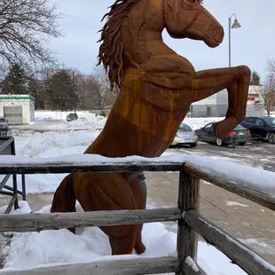 a wooden horse in the snow