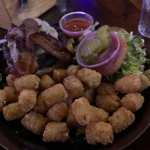 a plate of fried tater tots and bacon