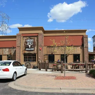 a white car parked in front of a restaurant