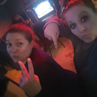 two women making a peace sign