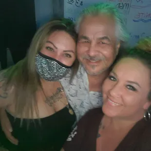 three people with bandanas on their faces