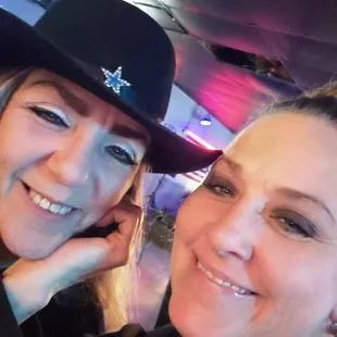 a woman and a woman with a cowboy hat