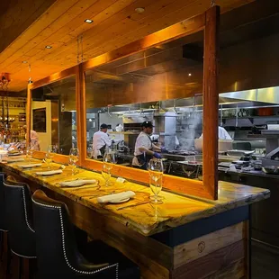 a restaurant kitchen with chefs preparing food