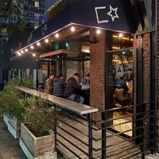 Indoor/outdoor seating. Sit inside looking out or outside looking in. I love this section. It sits 6 and fills up quickly on a nice night.