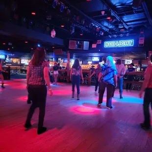 a group of people rollerblading at a bar
