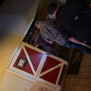two people standing in front of a barn door