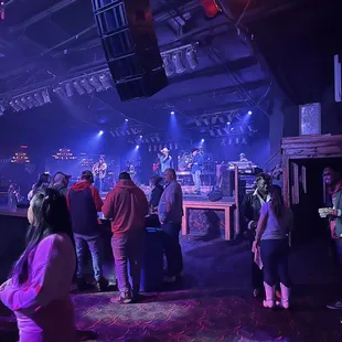 a group of people standing around a bar