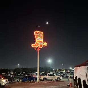 a neon cowboy boot sign