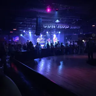 The band on stage across from the circular dance floor