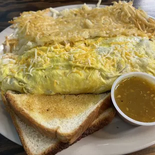Meat omelette with hash browns and toast. Salsa is spicy!