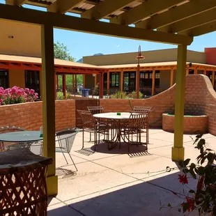a patio with tables and chairs