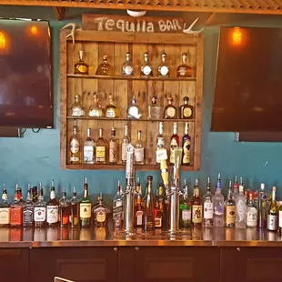 a bar with a lot of liquor bottles
