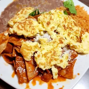 Red chilaquiles w scrambled eggs, beans &amp; rice. SO GOOD