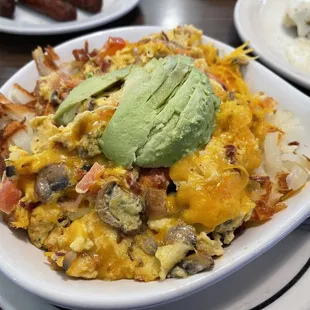 a plate of food with avocado on top